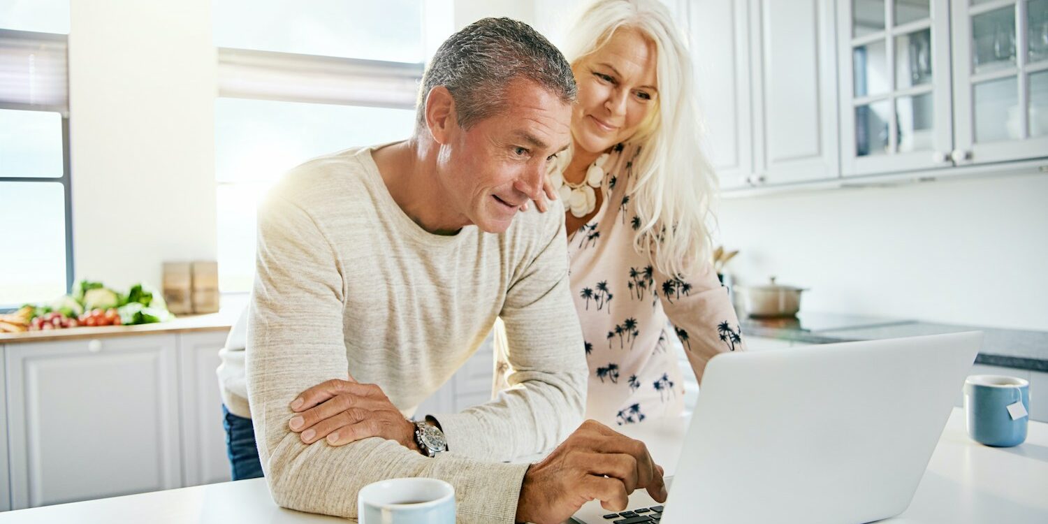 Elderly retired couple reading their social media